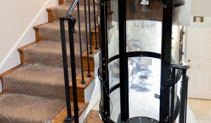 A home elevator shown by a set of stairs